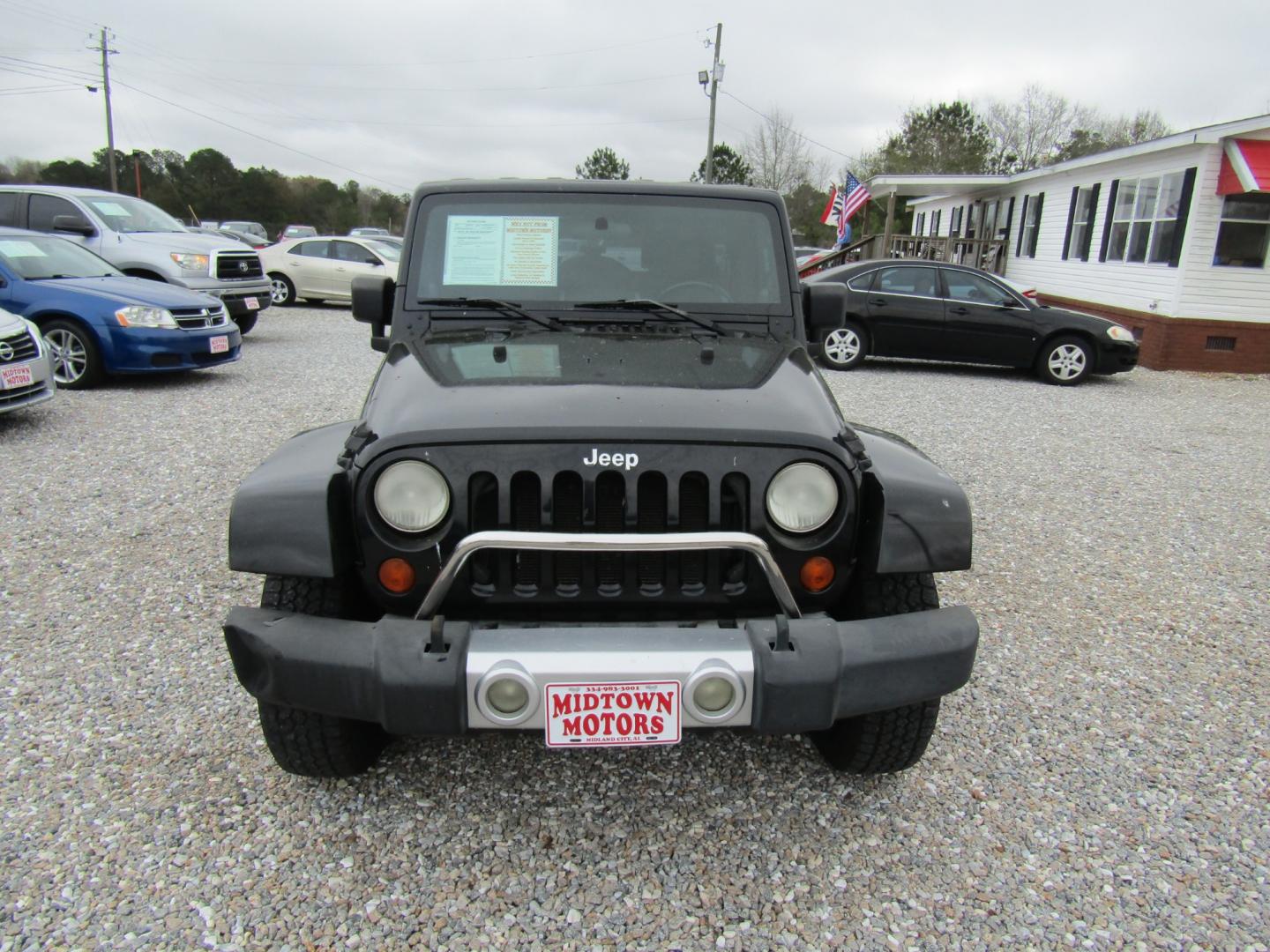 2008 Black Jeep Wrangler Unlimited Sahara 4WD (1J4GA591X8L) with an 3.8L V6 OHV 12V engine, Automatic transmission, located at 15016 S Hwy 231, Midland City, AL, 36350, (334) 983-3001, 31.306210, -85.495277 - Photo#1